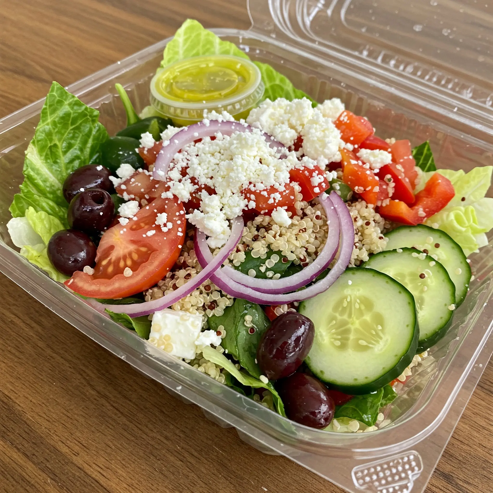 Fresh Greek salad in a plastic container.