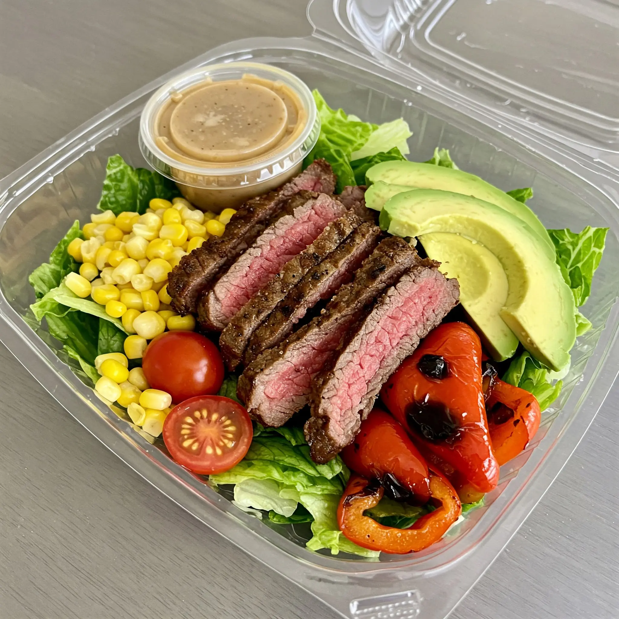 Steak salad with avocado and dressing.