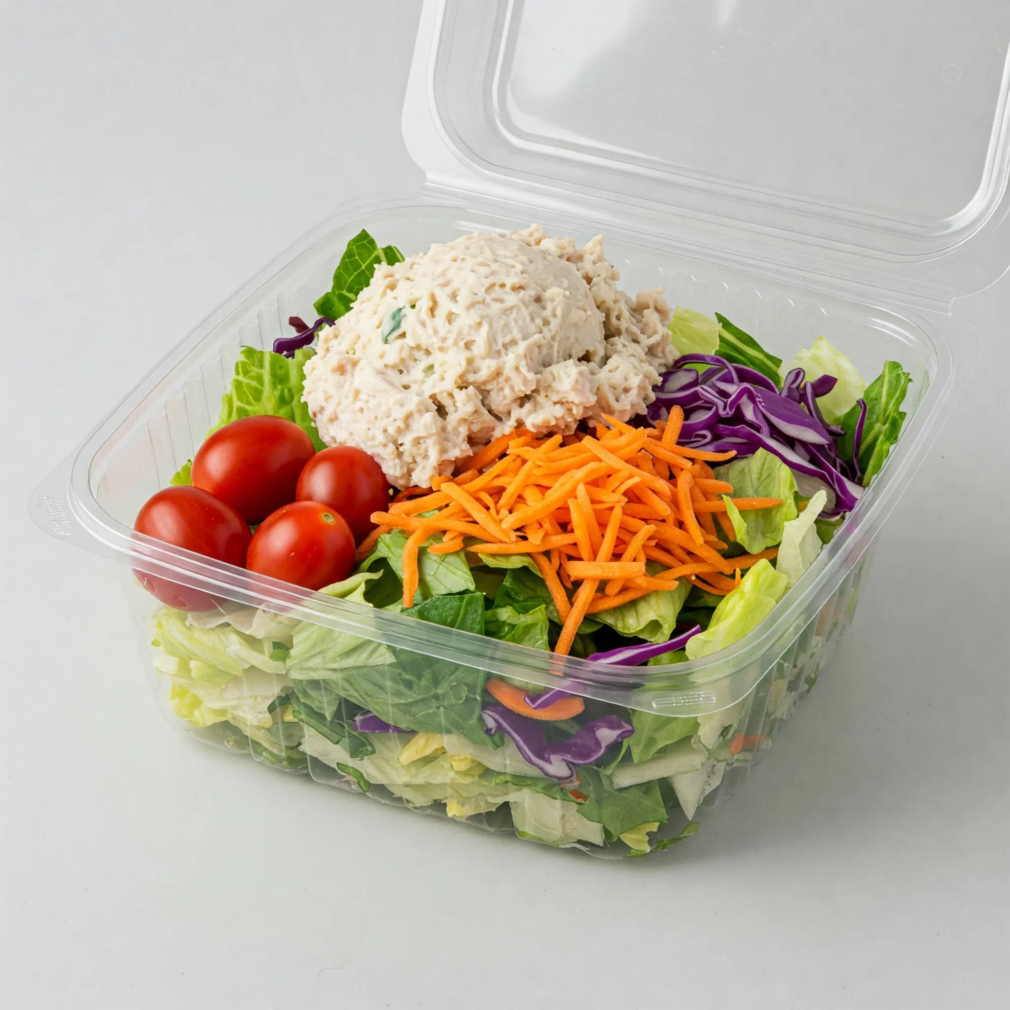 Salad with chicken, tomatoes, and shredded carrots.