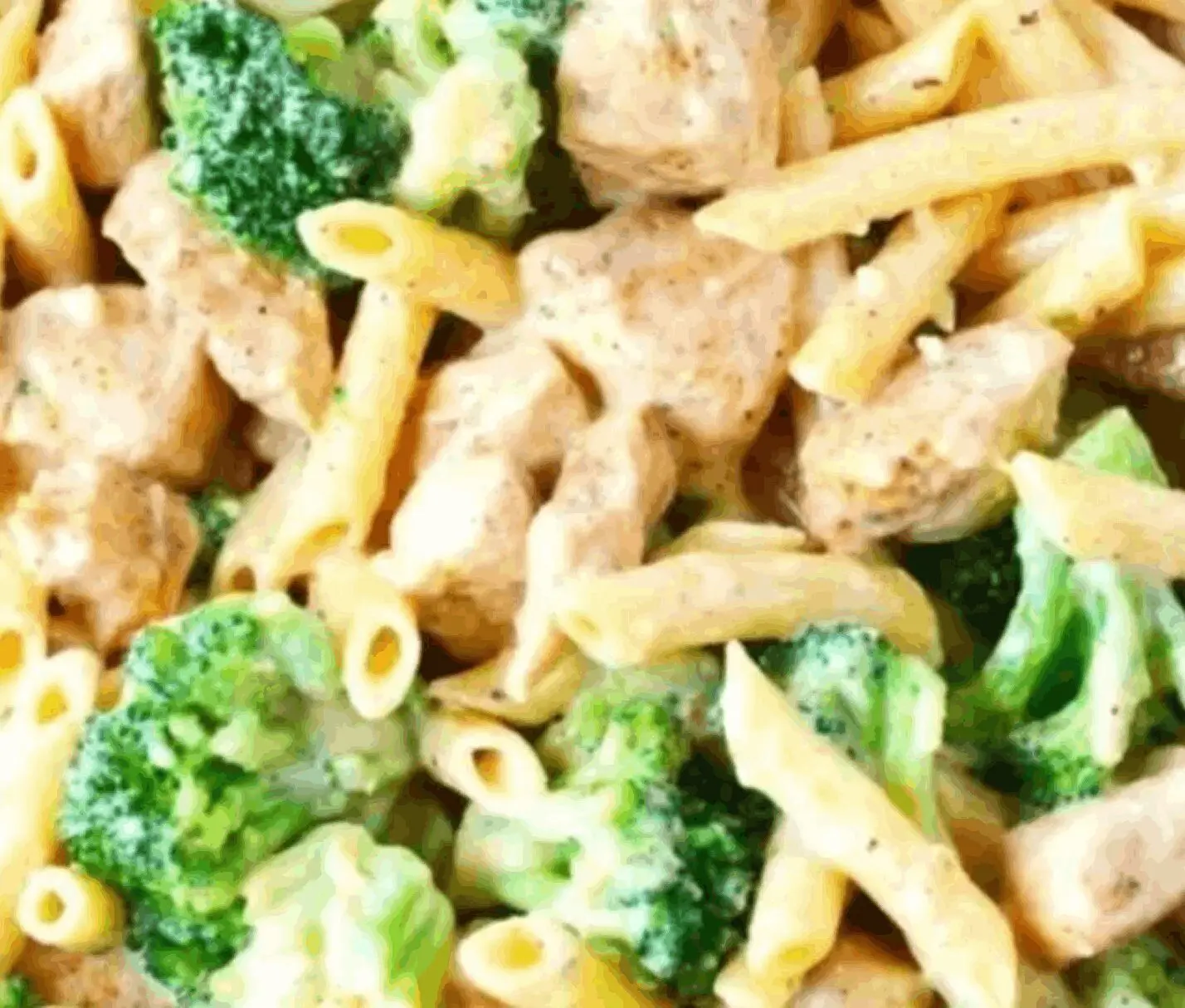 Pasta with chicken and broccoli in sauce.