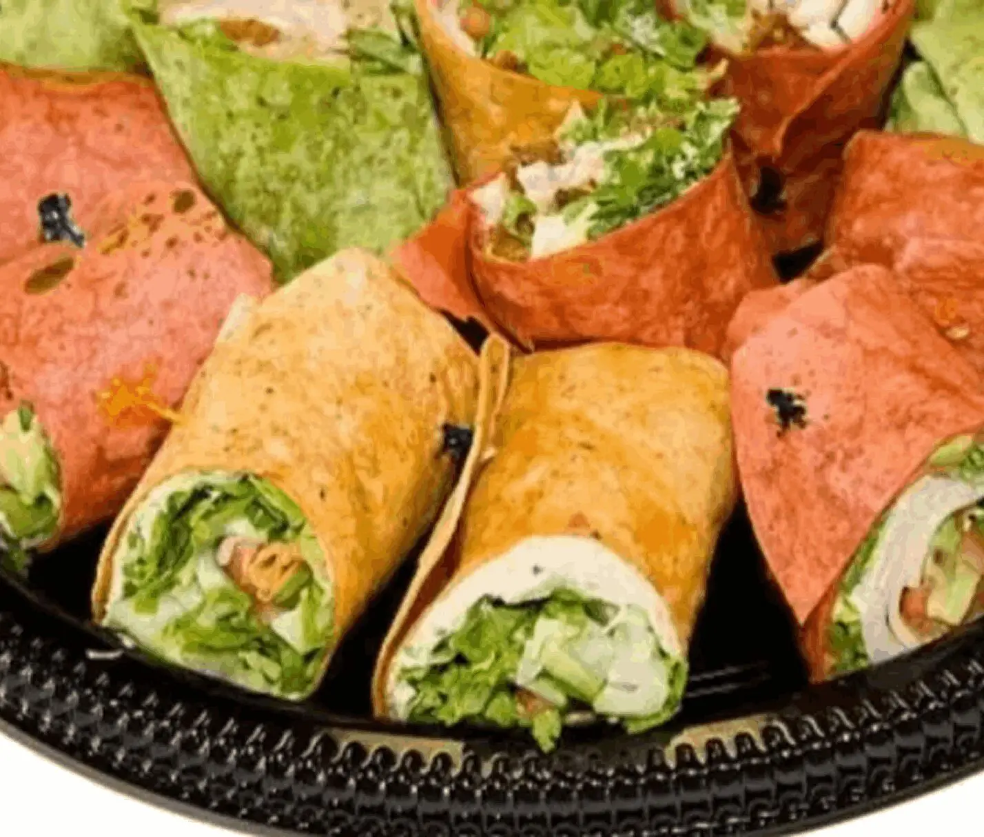 Colorful wraps filled with fresh greens.