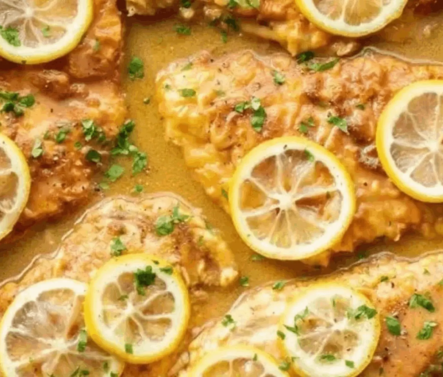 Lemon chicken garnished with parsley.