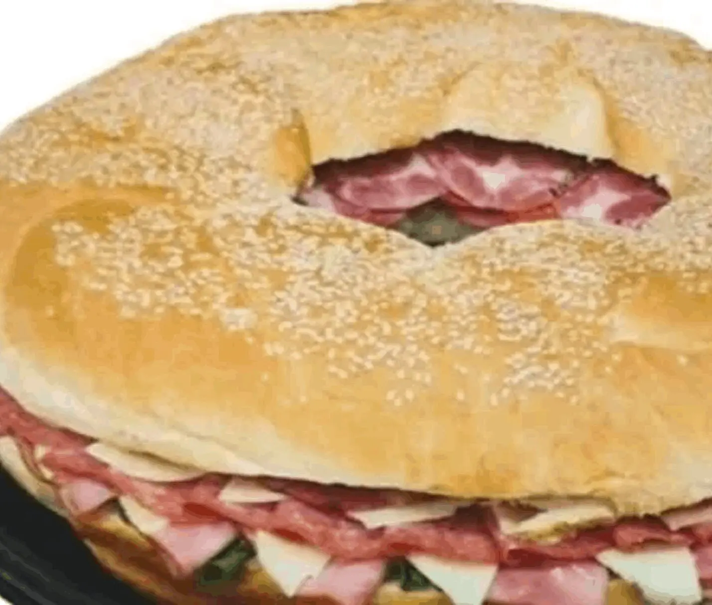 Large sandwich with meat and cheese filling.