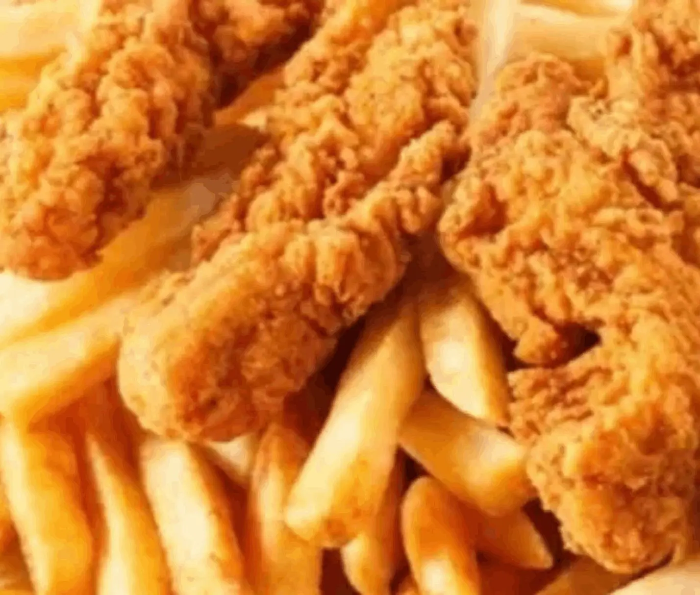 Fried chicken tenders with crispy French fries.